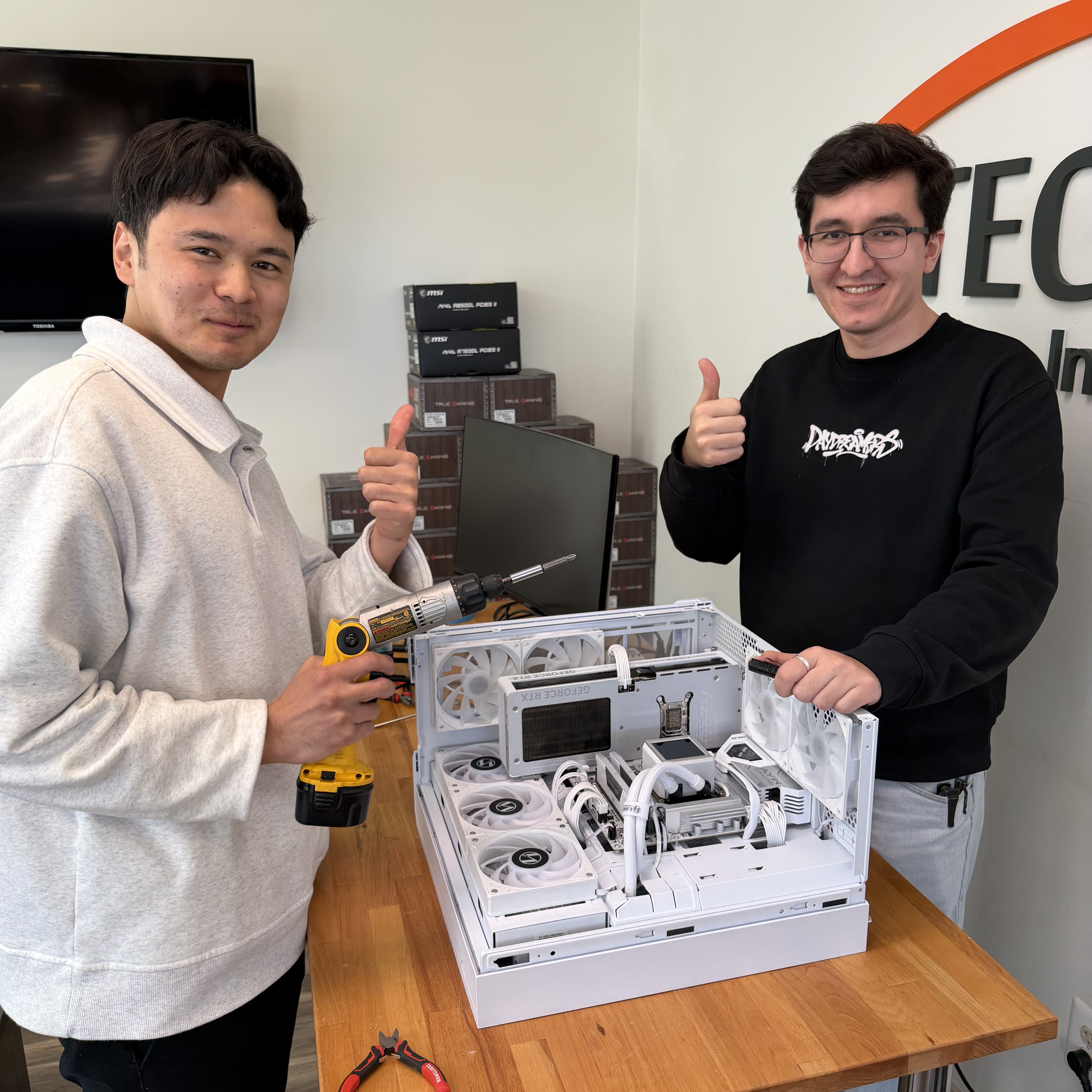 Shak and Anish with a completed custom white gaming PC build featuring liquid cooling at Fateka Computer Store, Herndon, VA